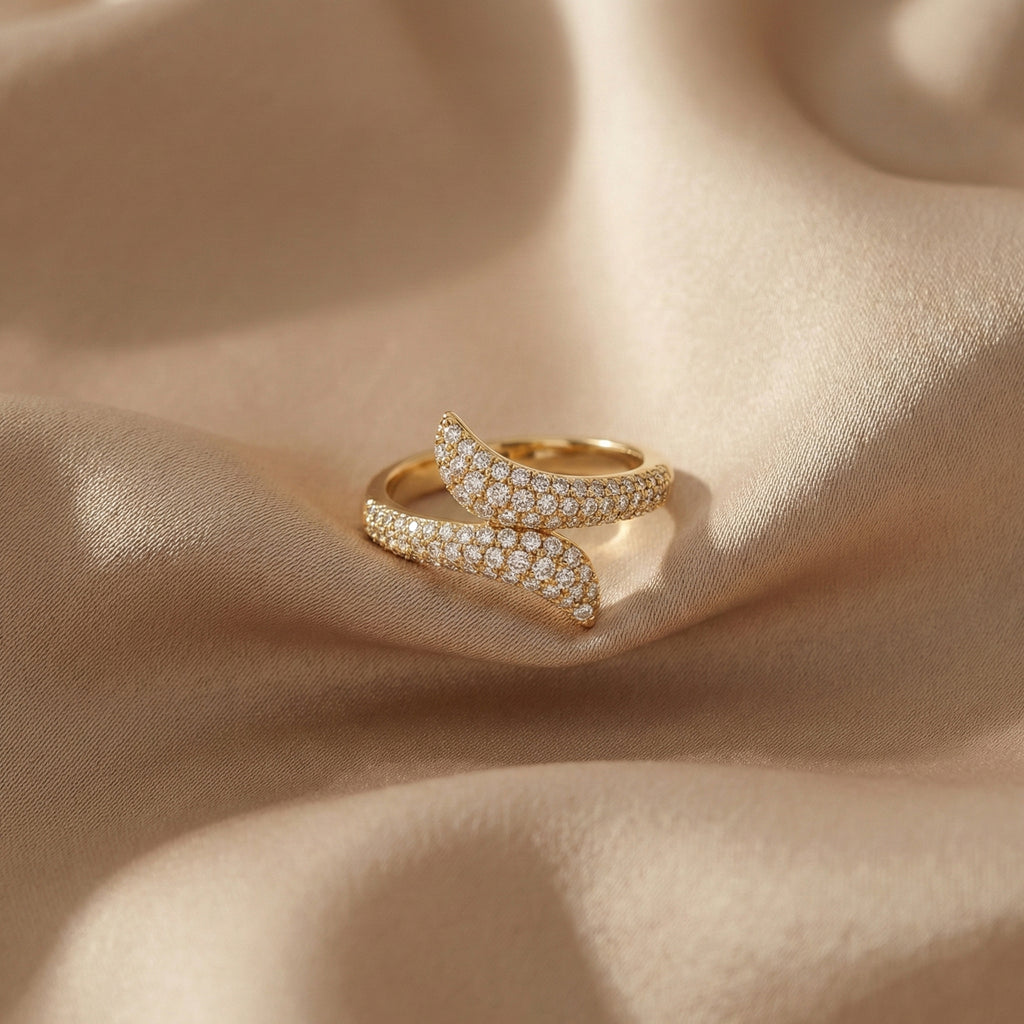 Gold ring with diamond accents on a beige fabric background