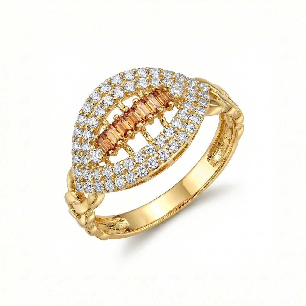 Gold ring with diamond and orange gemstone on a white background