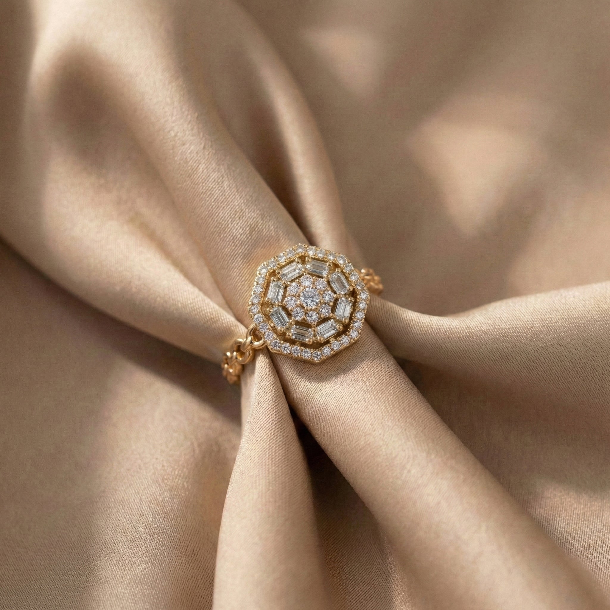 Gold ring with diamond accents on beige fabric