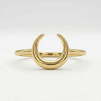 Front view of a Lamar 18k yellow gold crescent moon ring, lying flat against a crisp, pure white background to showcase its polished structural details.