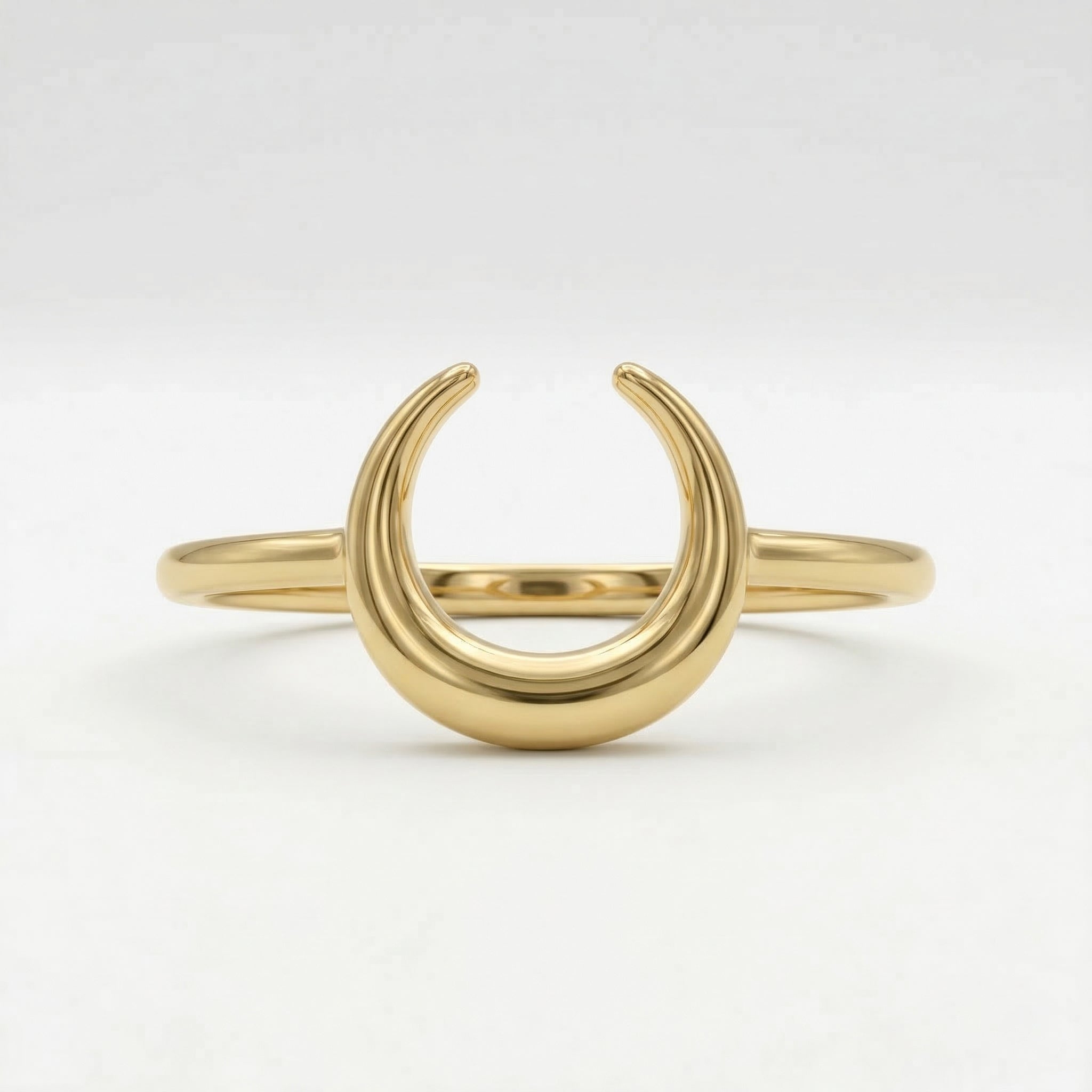 Front view of a Lamar 18k yellow gold crescent moon ring, lying flat against a crisp, pure white background to showcase its polished structural details.