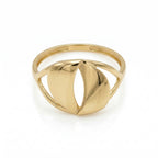 A top-down front view of an Andria 18k yellow gold ring lying flat on a pure white surface, showcasing the distinctive cut-out center and the smooth, reflective curves of the gold.