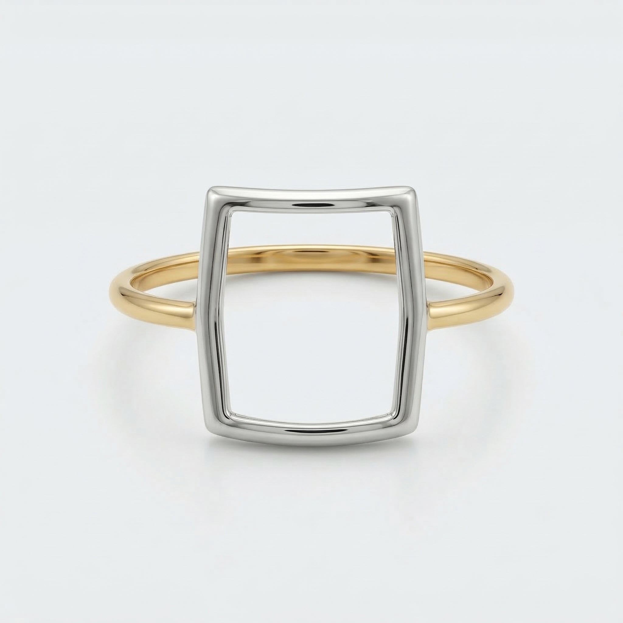 Front flat-lay view of the Alyans 18k yellow gold ring, lying against a crisp white background to clearly showcase its geometric mixed-metal structure.