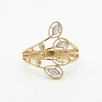 Front flat-lay view of the Andria 18k yellow gold ring, lying against a crisp white background to highlight its intricate, nature-inspired openwork and pearlescent leaf details.