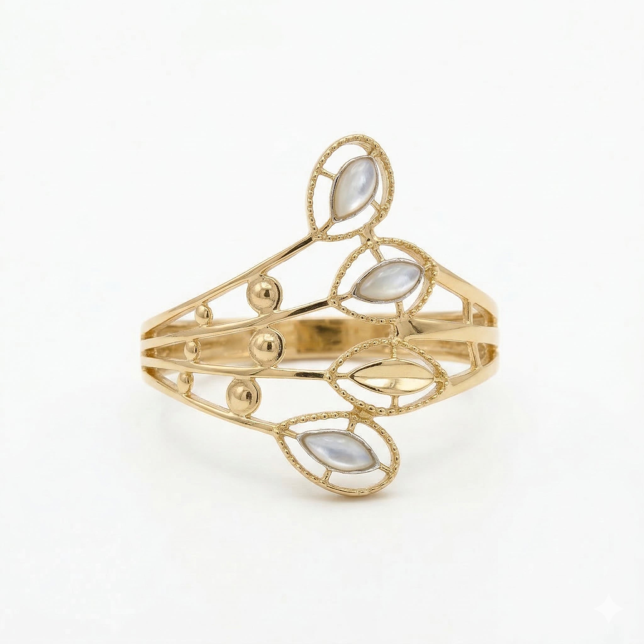 Front flat-lay view of the Andria 18k yellow gold ring, lying against a crisp white background to highlight its intricate, nature-inspired openwork and pearlescent leaf details.