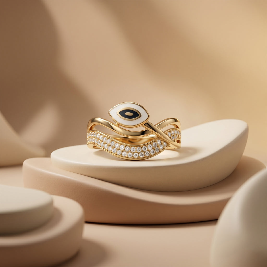 Dreams Gold 18k yellow gold evil eye ring elegantly displayed on smooth, modern beige sculptural pedestals under soft diffused luxury studio lighting. خاتم ذهب عيار 18 من دريمز جولد بتصميم العين معروض بأسلوب فني على منصات بيج ناعمة تحت إضاءة استوديو فاخرة.