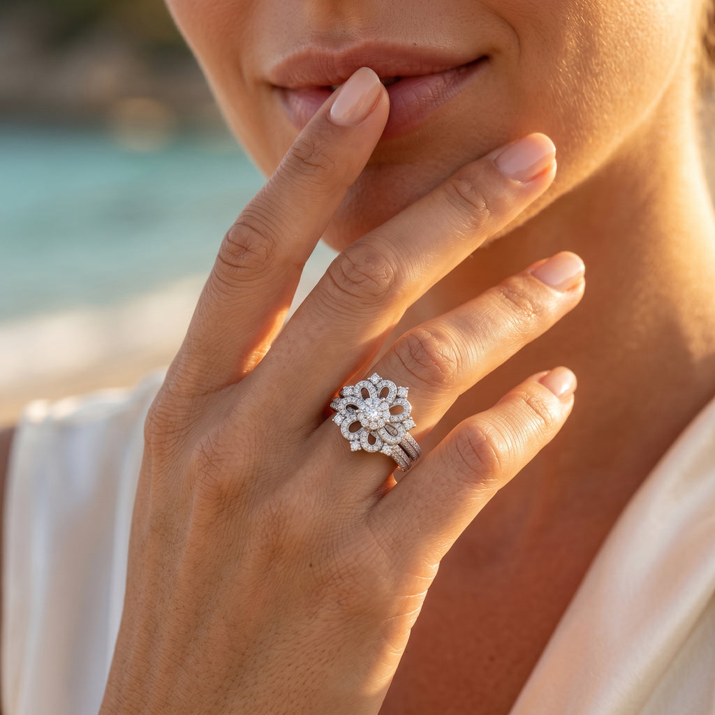 Extreme macro shot of a woman wearing the 7.61g Egypt Gold floral white gold twin ring set posed delicately near her lips.	لقطة مقربة ليد عارضة ترتدي طقم خواتم توينز ذهب أبيض بتصميم وردة 7.61 جرام من إيجيبت جولد بالقرب من شفتيها.