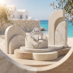 Luxury product photography of the 7.61g Egypt Gold floral white gold twin rings displayed on a modern travertine pedestal with a Mediterranean background.	تصوير منتج فاخر لطقم خواتم توينز ذهب أبيض بتصميم وردة من إيجيبت جولد بوزن 7.61 جرام معروض على قاعدة معمارية أنيقة.