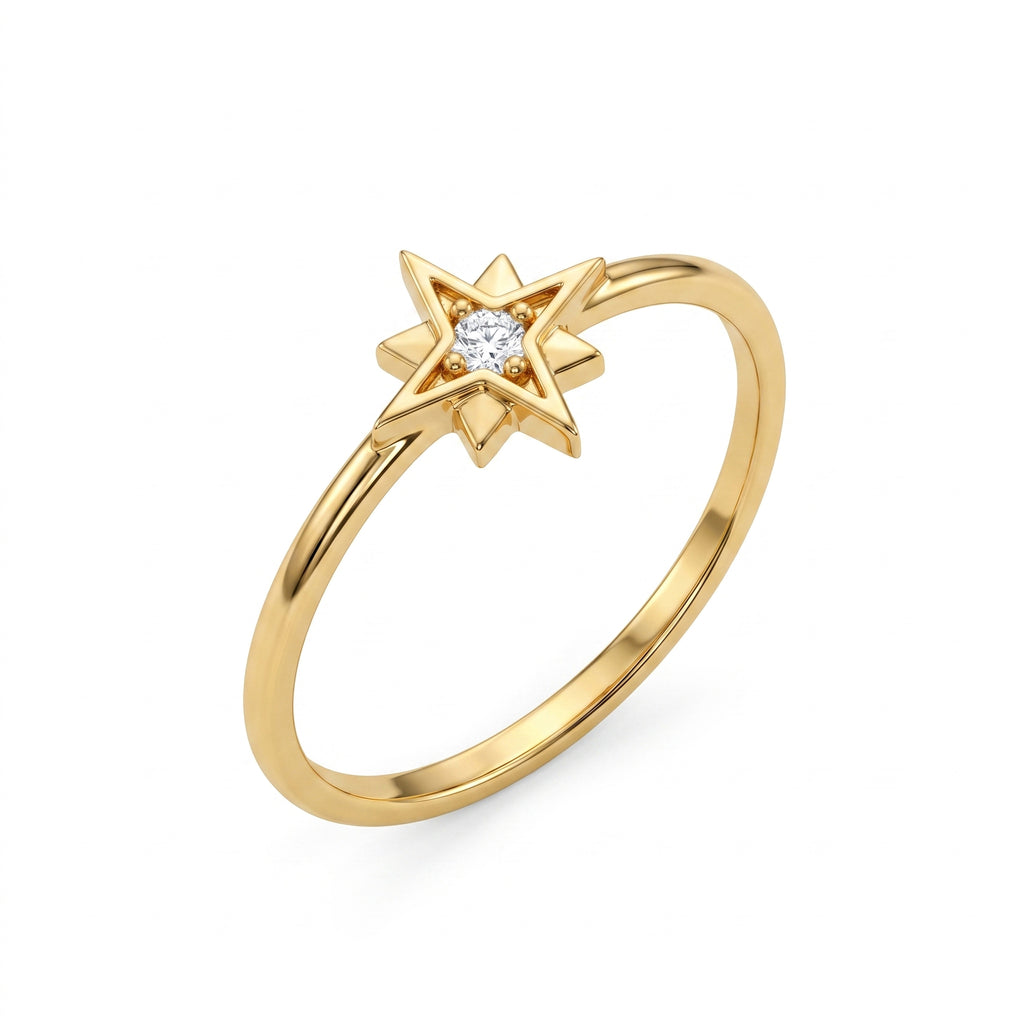 An angled product shot of a delicate 18k yellow gold star ring by Remas Gold featuring a central stone, set against a pure white background.	صورة تفصيلية بزاوية لمنتج خاتم نجمة رقيق من الذهب الأصفر عيار 18 من ريماس جولد يتوسطه فص، معروض على خلفية بيضاء نقية.