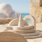 Andria 18k gold white stone ring displayed on an elegant travertine pedestal with a coastal Mediterranean background.	خاتم أندريا من الذهب عيار 18 بفص أبيض معروض على منصة حجرية أنيقة مع خلفية ساحلية متوسطية.
