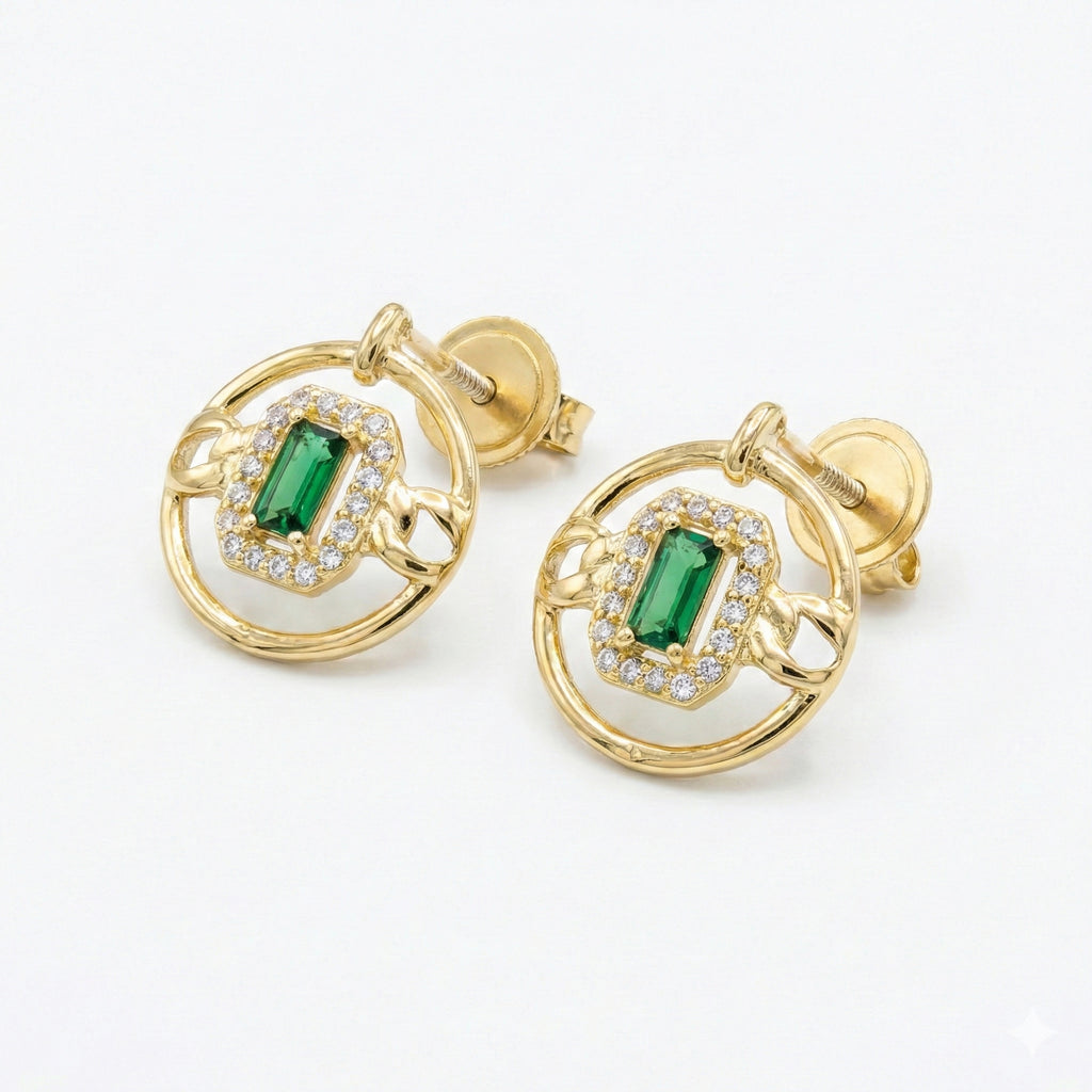 Gold earrings with green gemstones on a white background
