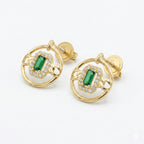 Gold earrings with green gemstones on a white background