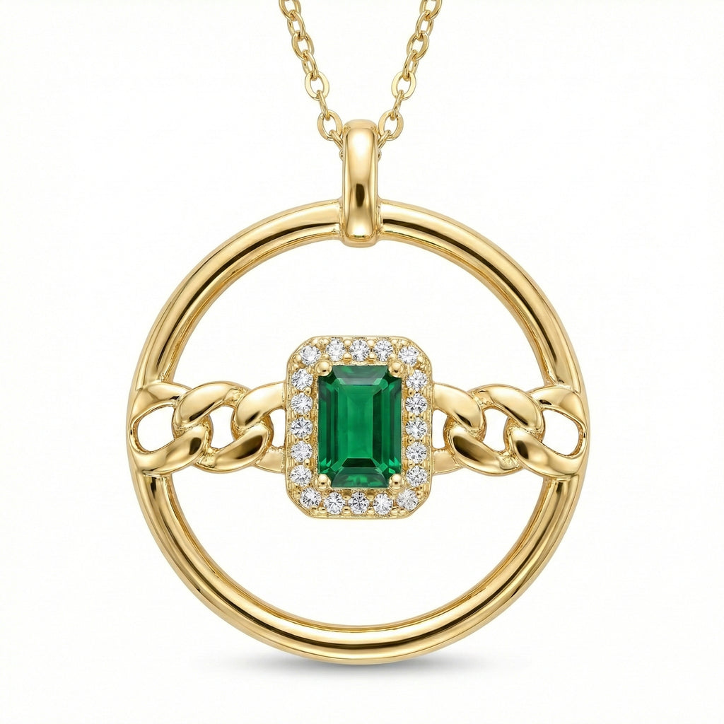 Gold pendant with a green gemstone and chain design on a white background