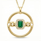 Gold pendant with a green gemstone and chain design on a white background