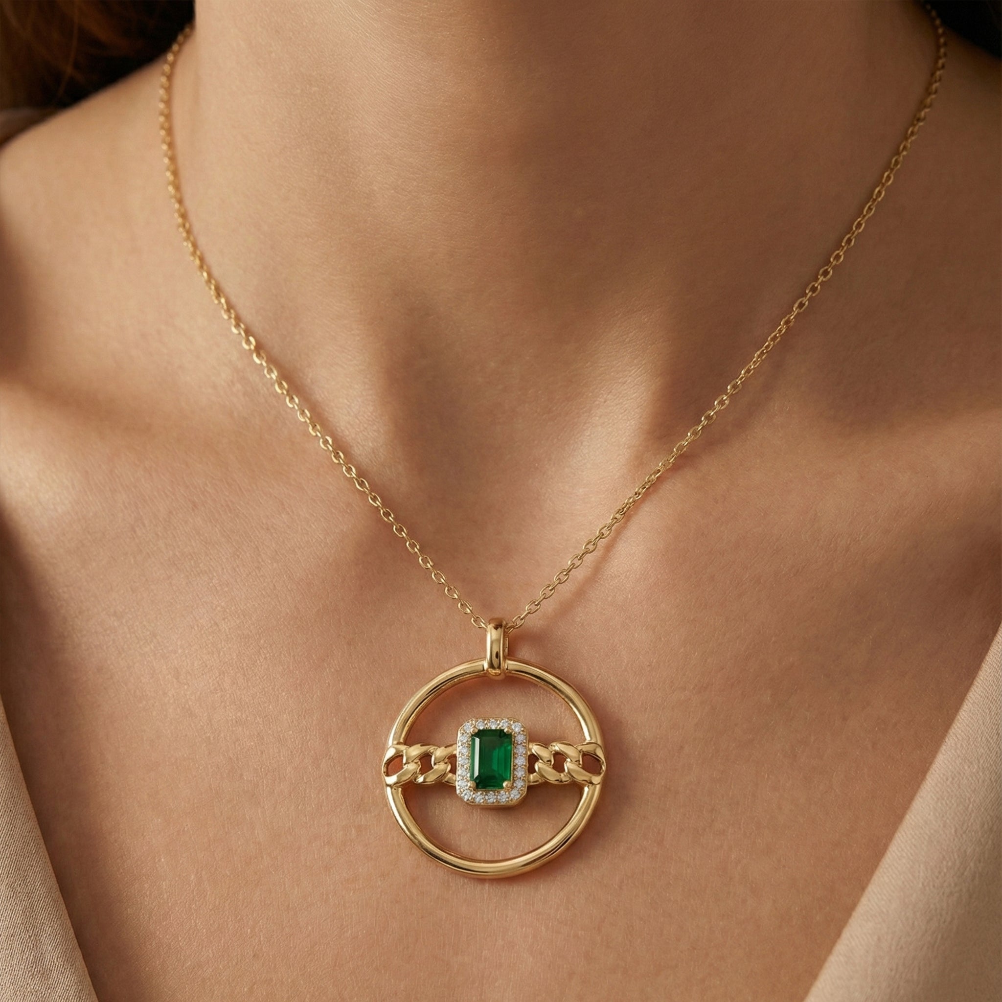Gold necklace with a green gemstone pendant on a person's neck