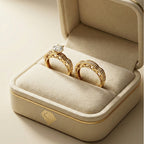 Gold rings with diamonds in a beige jewelry box