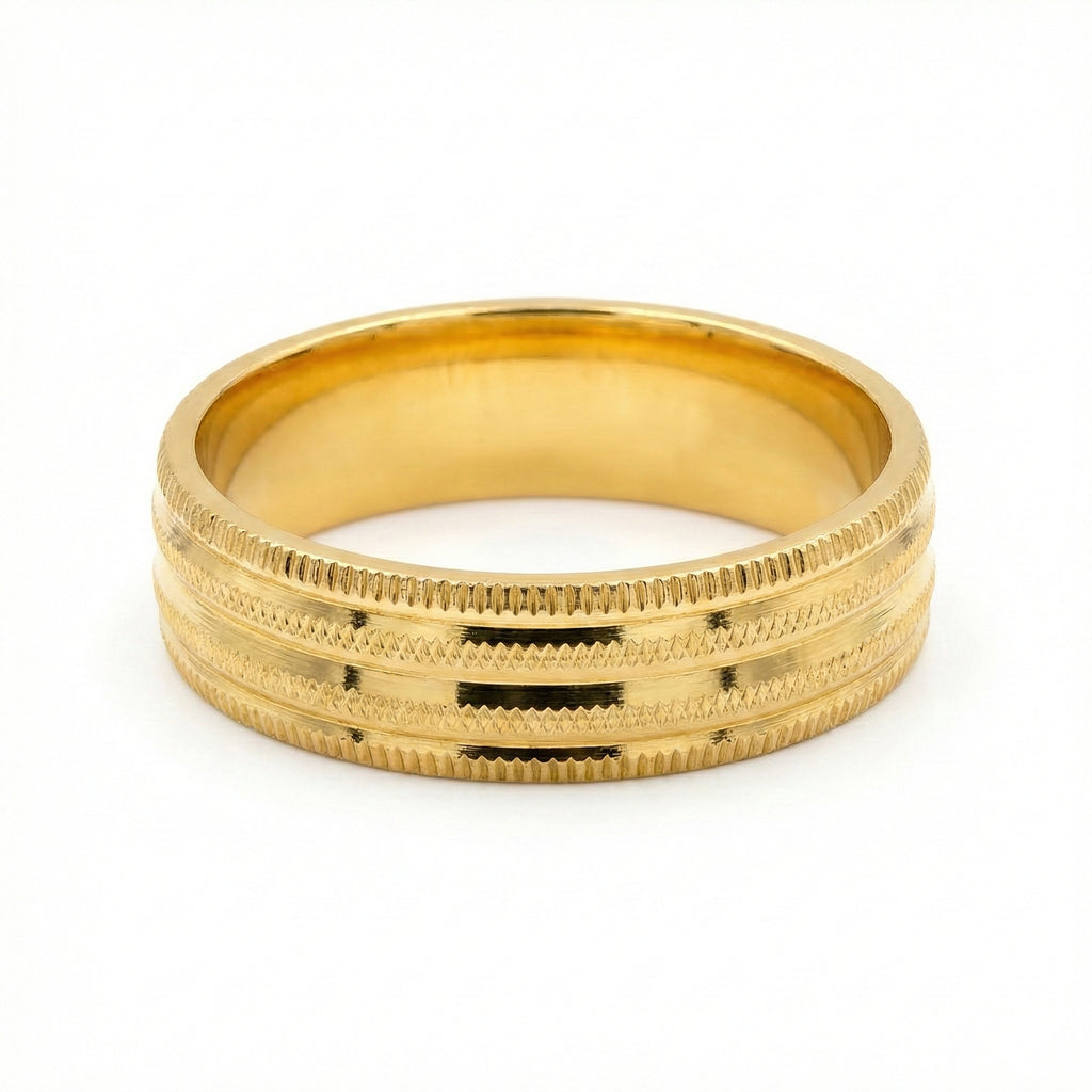Gold ring with textured design on a white background