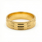 Gold ring with textured design on a white background