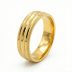 Gold ring with textured design on a white background