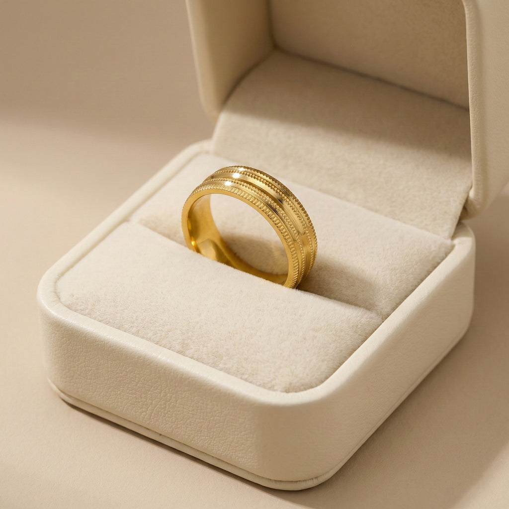 Gold ring in a jewelry box on a beige background