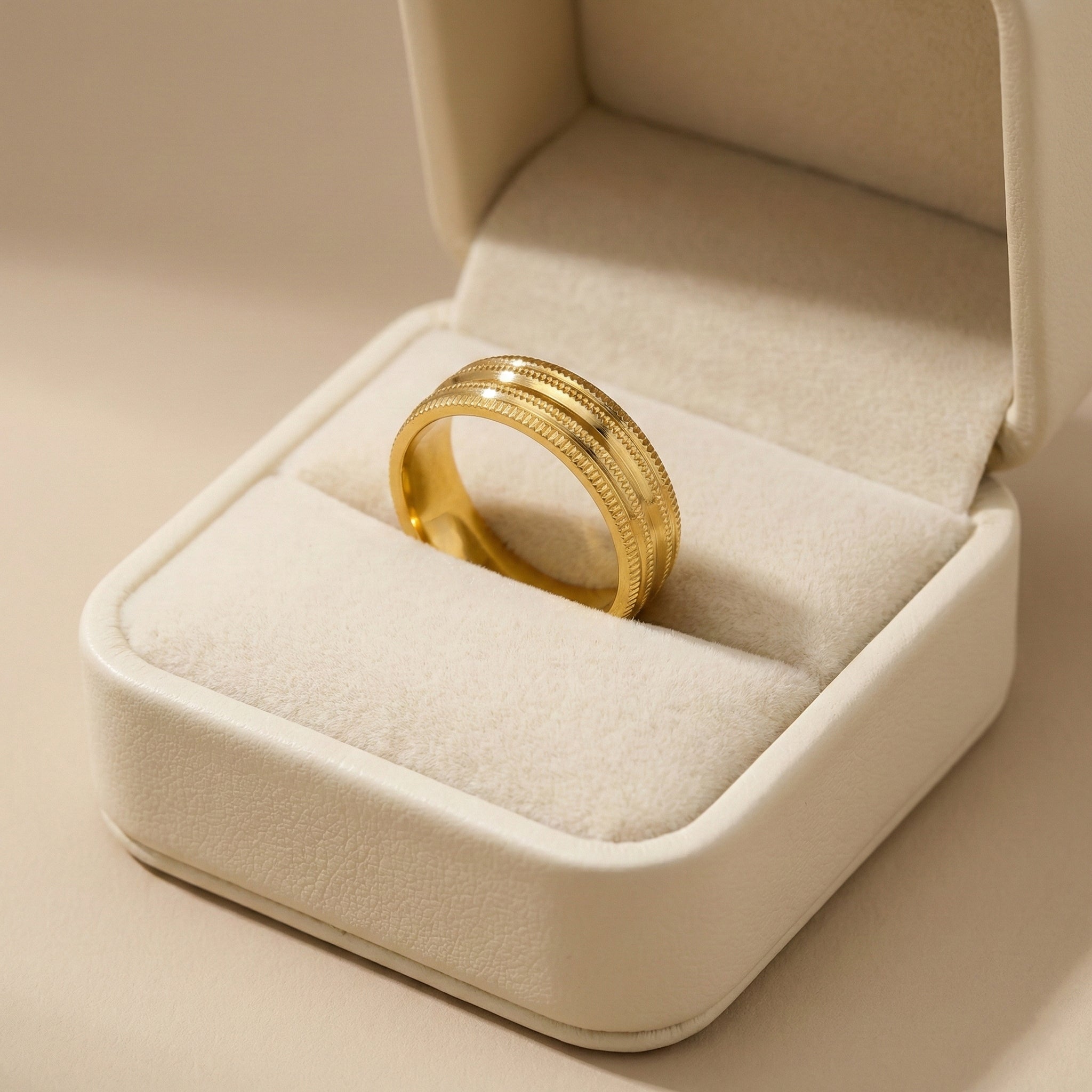 Gold ring in a jewelry box on a beige background