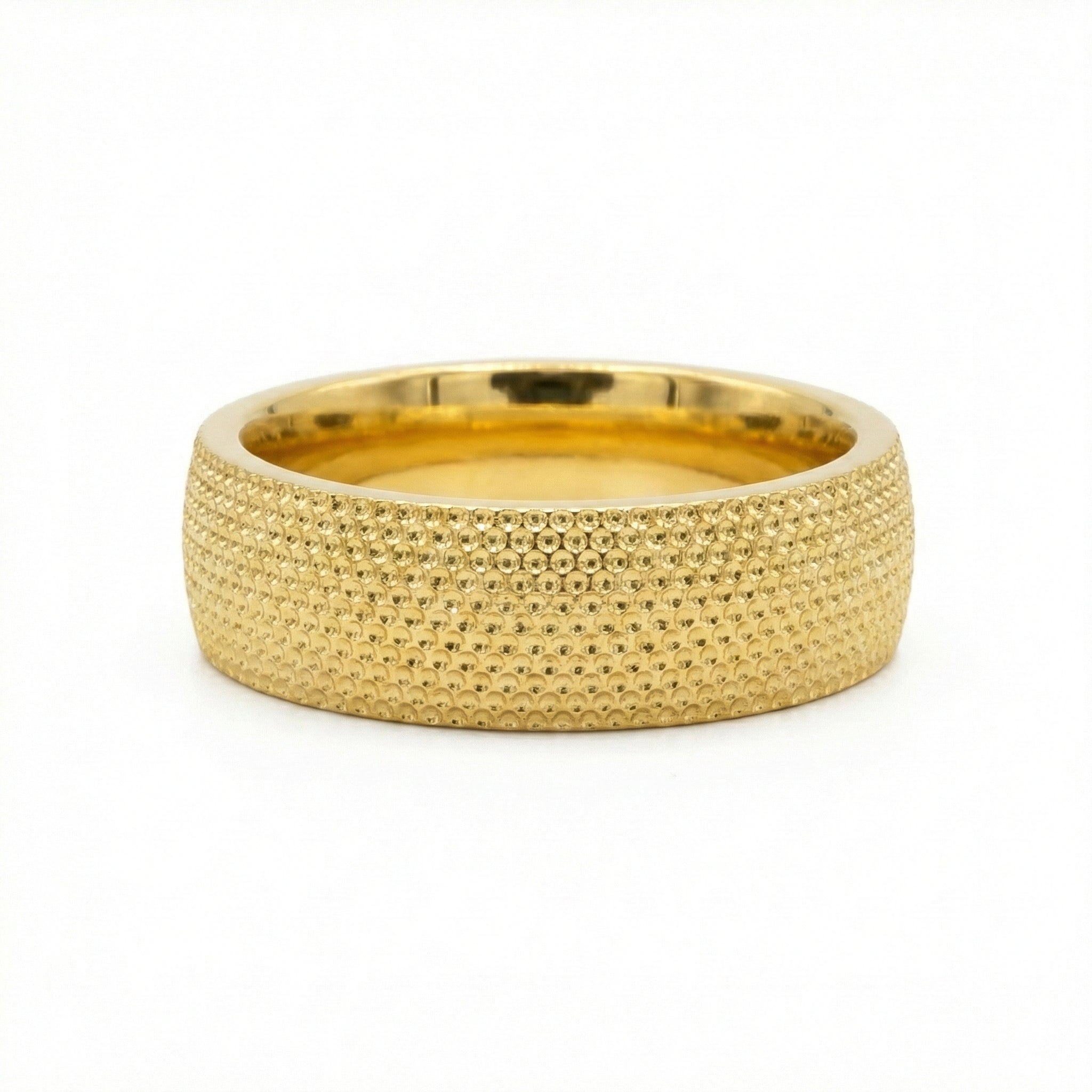 Gold ring with textured surface on a white background