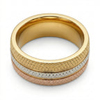 Gold ring with textured design on a white background