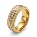 Gold, rose gold, and silver ring on a white background