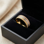 Gold ring with diamond accents in a black jewelry box