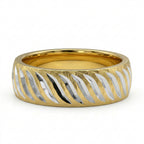 Gold and silver ring with wavy pattern on a white background