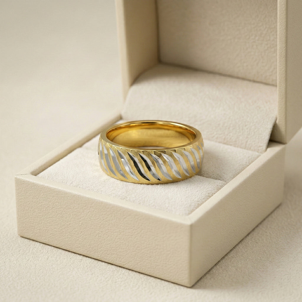 Gold and silver ring in a beige jewelry box