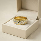 Gold and silver ring in a beige jewelry box