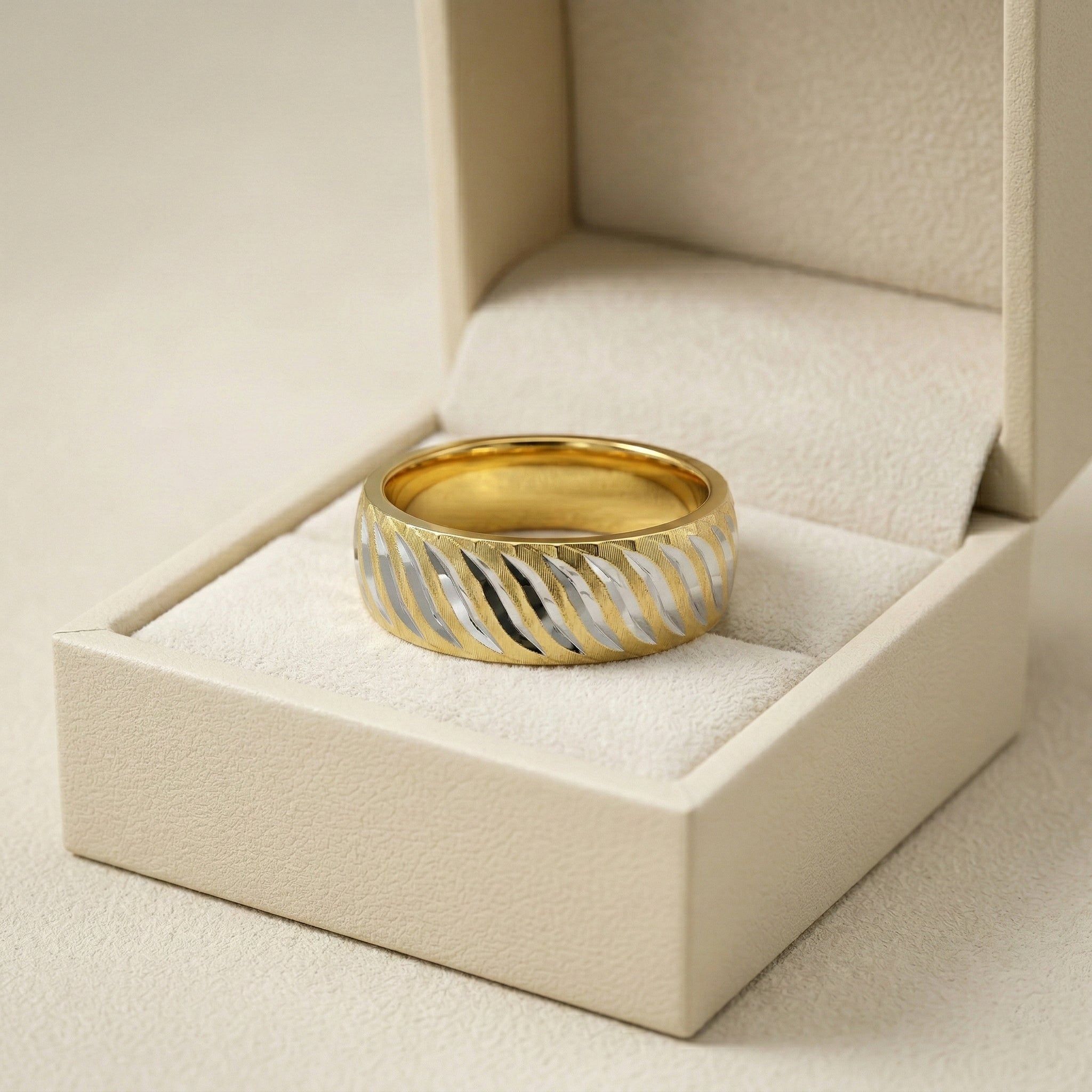 Gold and silver ring in a beige jewelry box