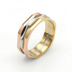 Three-toned gold ring with rose gold, yellow gold, and silver band on a white background
